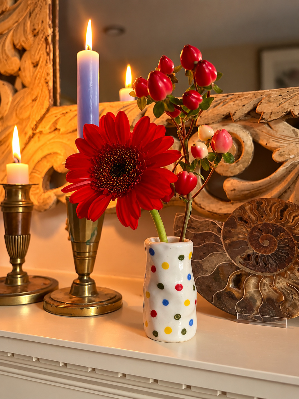 The Itsy-Bitsy Candle Holder used as a bud vase with red flowers beside lit candles