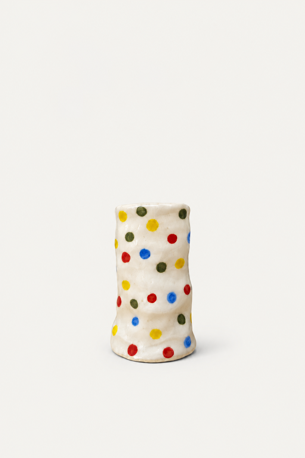 The Itsy-Bitsy Candle Holder with red, yellow, blue and olive-green dots on a creamy glaze